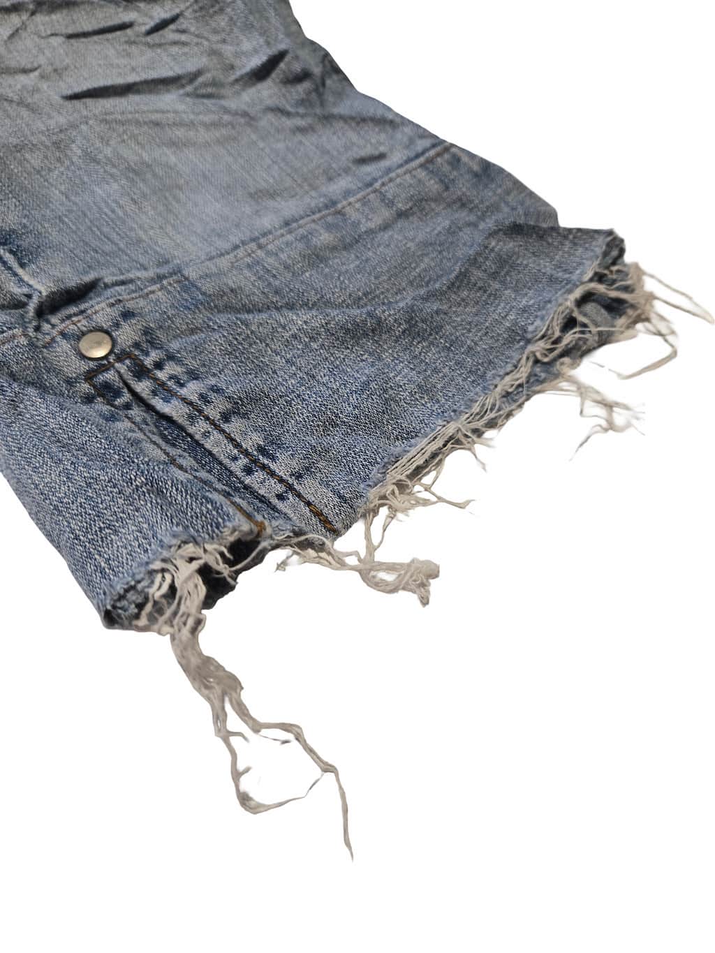 Détail zoomé d'un défaut sur un pantacourt Lee et Levi's issu d'un lot Grade B.